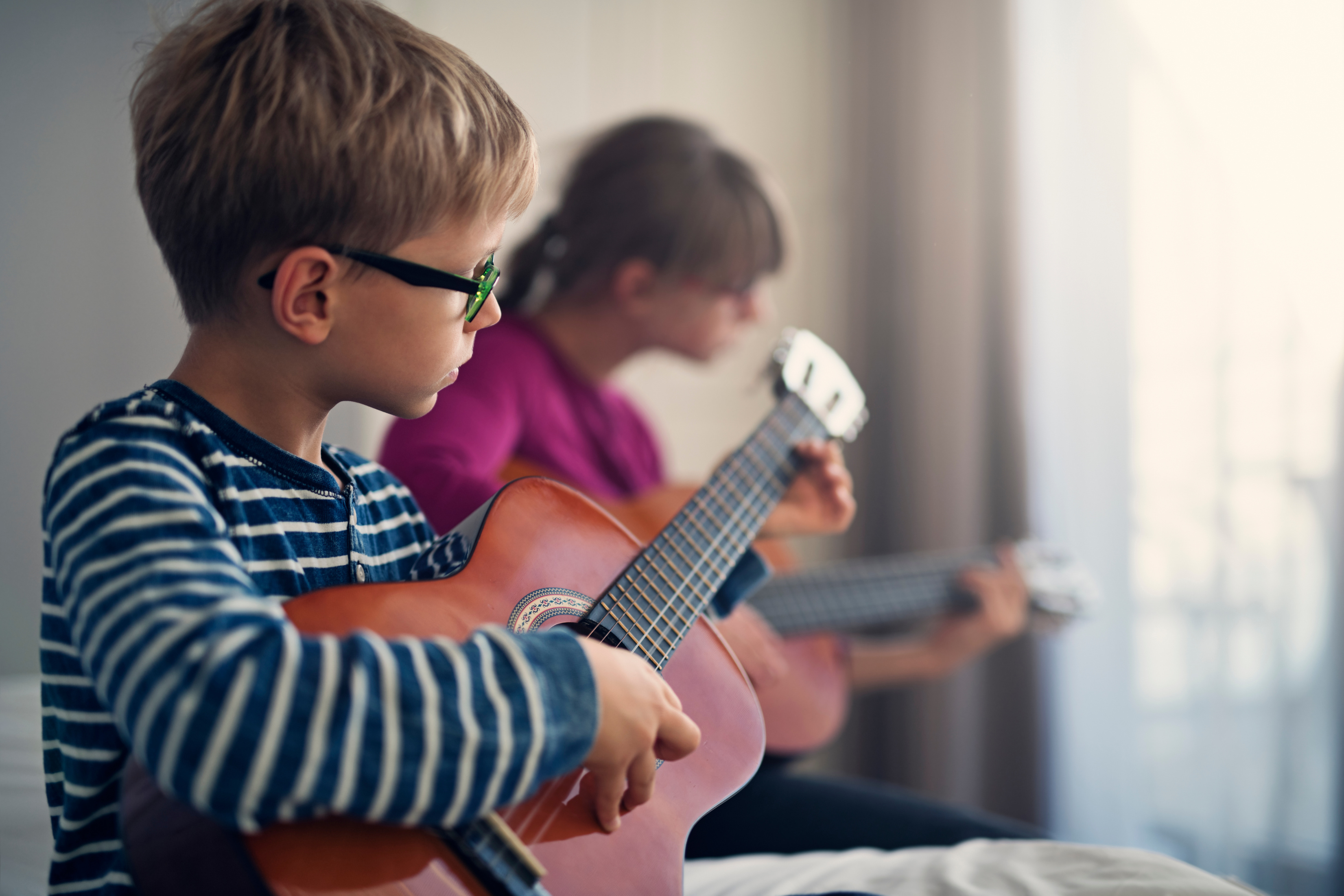 Kids playing guitars together